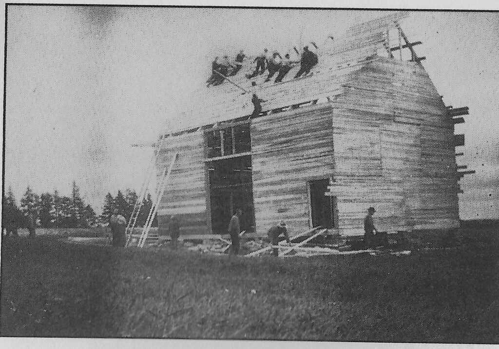 Neighbours raising a barn frame, 1922