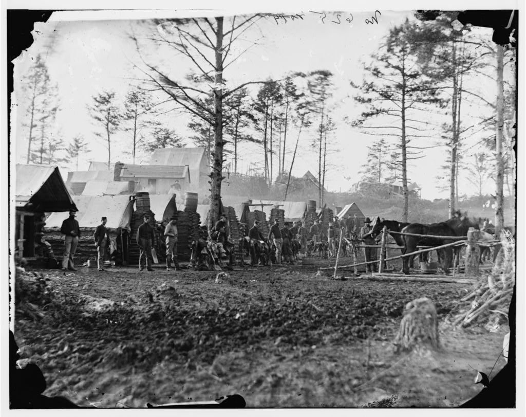 An American Civil War cavalry camp with tents, soldiers, and horses