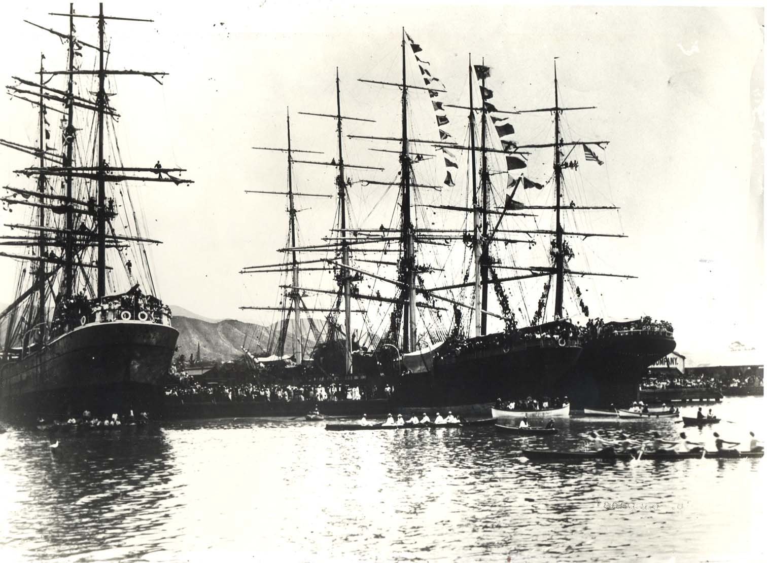 Tall sailing ships dressed with flags in Honolulu Harbor about 1900