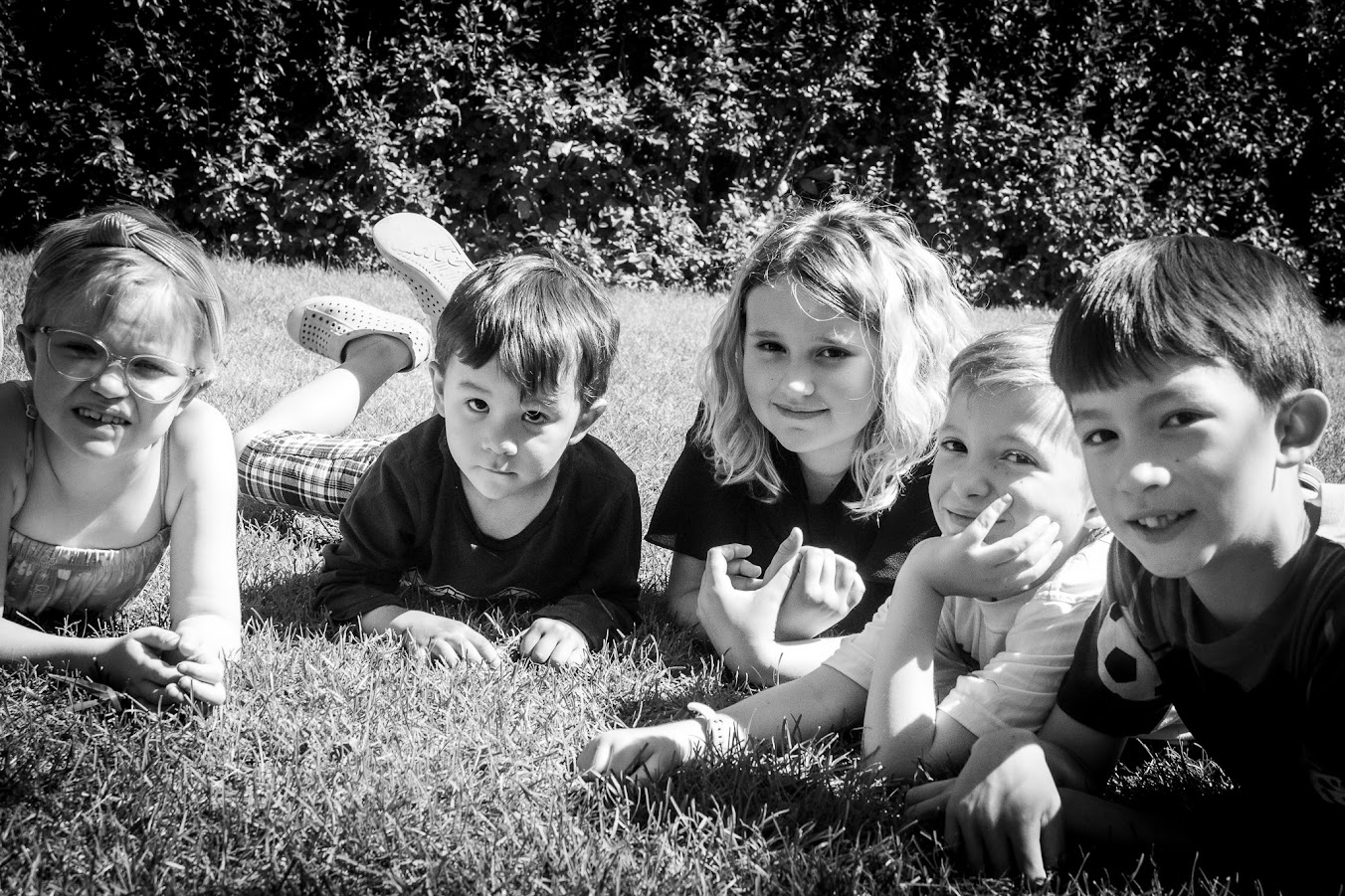Sebastian and Logan Cheesman lying on the grass on their elbows